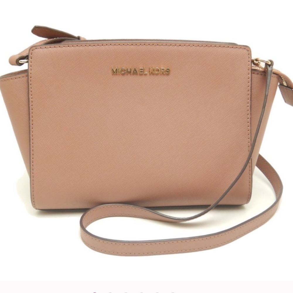 Practically brand new. Former employee owned. MINT CONDITION. 
MKTan Crossbody